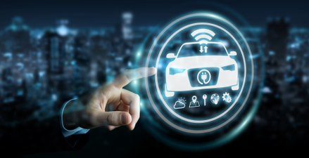 Hand interacting with futuristic car interface, featuring icons representing connectivity and technology, over cityscape.