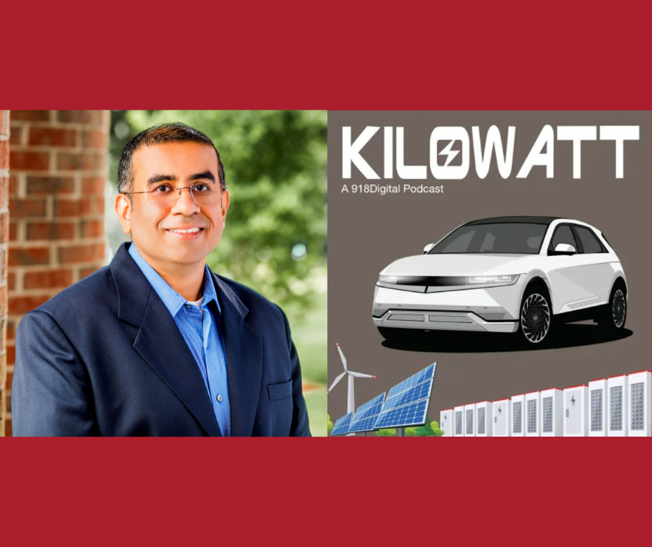 Man in suit smiling with a podcast cover featuring a car, solar panels, and "Kilowatt" text on a red background.