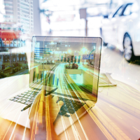 A laptop displays bar graphs, with a blurred cityscape and moving car in the background, symbolizing technology and speed.