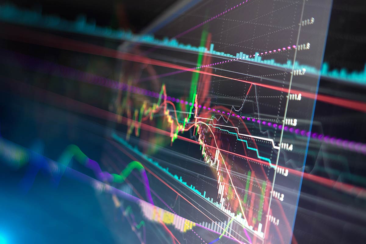 Colorful financial stock market graph with fluctuating lines showing economic data on a dark background.