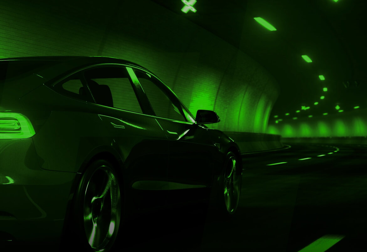 A sleek car drives through a tunnel, illuminated by green lights, creating a futuristic atmosphere.