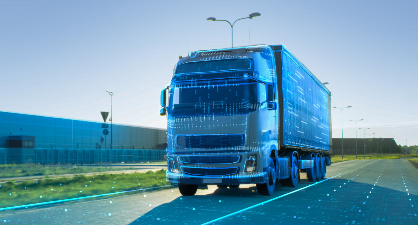 Futuristic digital concept of a truck with transparent overlay on a road near a warehouse.