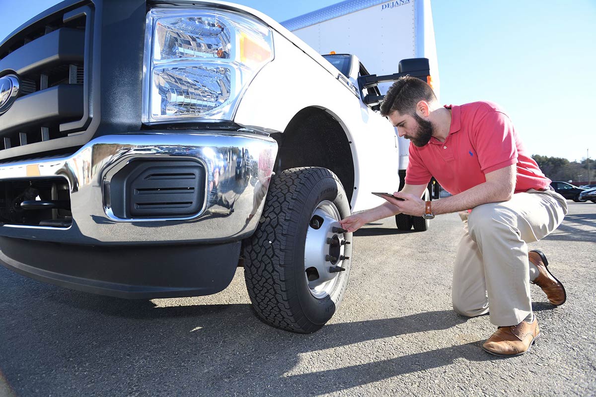 Man checking tire safety